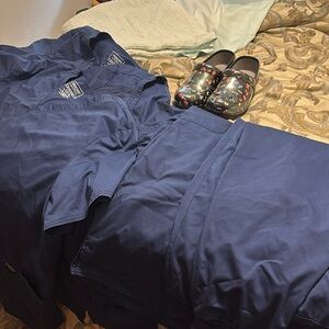 3 Cherokee scrub tops. 2 3X and 1 4X. 2 Cherokee scrub bottoms size 3X.